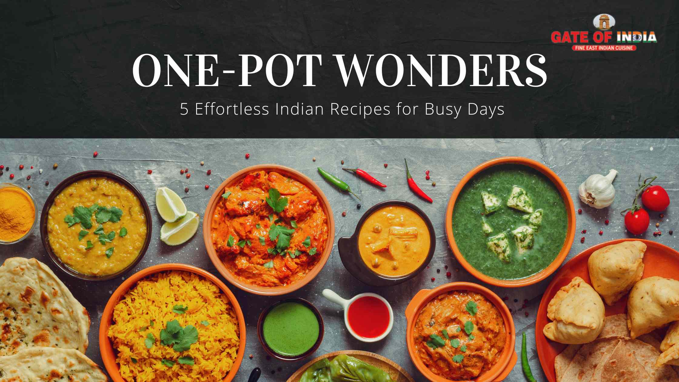 Dal, butter chicken, palak paneer, rice, naan, and samosas spread at Gate of India Calgary